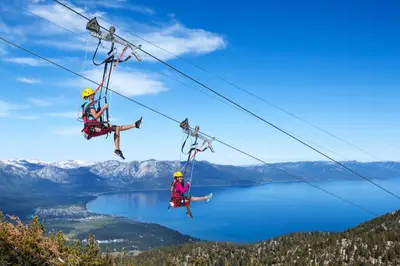two people on a zip line over a lake at Pinnacle Stateline Resort BBQ Hot Tub Pool Zalanta 214 in Stateline