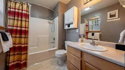 a bathroom with a sink and a toilet and a shower at Stylish Truckee Retreat Deck Near Lake Skiing Moraine by AvantStay in Truckee