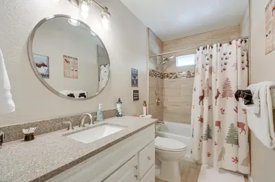 a bathroom with a sink and a toilet and a mirror at Coulterville Home with Gazebo Near Lakes and Hiking! in Coulterville