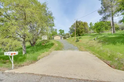 a dirt road leading to a house on a hill at Coulterville Home with Gazebo Near Lakes and Hiking! in Coulterville