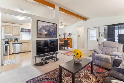 a living room with a couch and a table at Lincoln Lodge cabin in Groveland