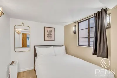 a bedroom with a white bed and a window at Midtown Gem with Secret Speakeasy in Sacramento