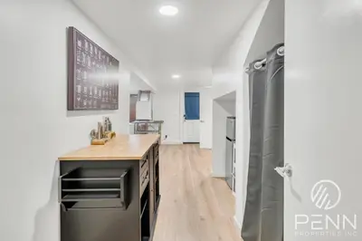 a kitchen with a refrigerator and a counter top at Midtown Gem with Secret Speakeasy in Sacramento