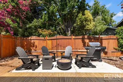 a patio with chairs and a table and a grill at Midtown Gem with Secret Speakeasy in Sacramento