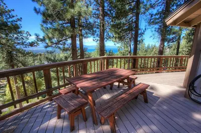 a wooden deck with a picnic table and benches at HCH1221 - Tahoe Bonoff Venture home in South Lake Tahoe