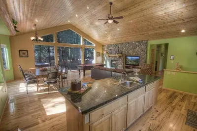 a large kitchen and living room with a table and a couch at COH1669 - Hawk's View Hideaway home in South Lake Tahoe