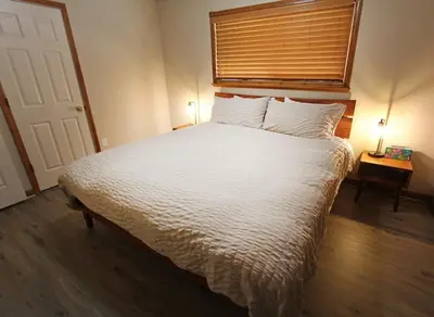 a bedroom with a large white bed with a window at COH1261 - Nature's Gem home in South Lake Tahoe