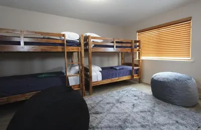 a room with three bunk beds and a rug at COH1261 - Nature's Gem home in South Lake Tahoe