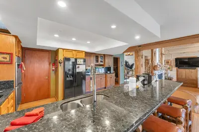 a kitchen with a granite counter top and wooden cabinets at HCH1239 - Heavenly Tree House home in South Lake Tahoe