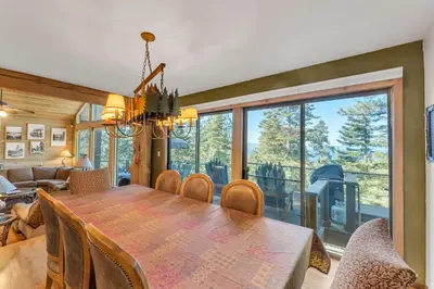 a dining room and living room with a table and chairs at HCH1239 - Heavenly Tree House home in South Lake Tahoe