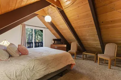 a bedroom with a large bed and two chairs at COH0885 - Skyline Divine home in South Lake Tahoe