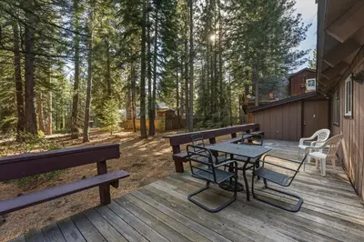a wooden deck with benches and a table at COH0885 - Skyline Divine home in South Lake Tahoe