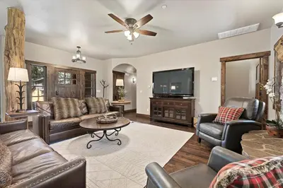 a living room with leather furniture and a flat screen tv at CYH1012 - Hidden Cedar home in South Lake Tahoe