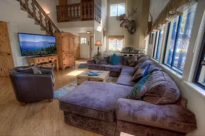 a living room with a couch and a tv at HCH1217 - Pinehill Ponderosa home in South Lake Tahoe