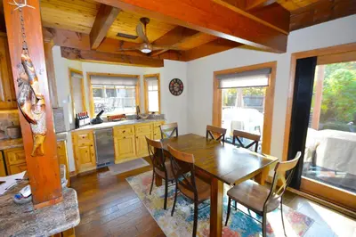a kitchen with a wooden table and chairs at Deer Lodge #1 Lake front in Bass Lake