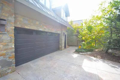 a garage with a black garage door on a brick building at Deer Lodge #1 Lake front in Bass Lake