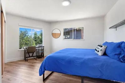 a bedroom with a blue bed and a table at HCH1083 - Mountain Serenity home in South Lake Tahoe