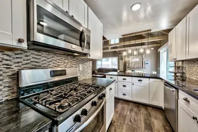a kitchen with white cabinets and a stove top oven at CYH0876 - Island Cabin cabin in South Lake Tahoe