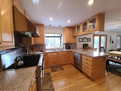 a kitchen with wooden cabinets and a stove top oven at IVH0869 - Cinnabar Creek home in Incline Village