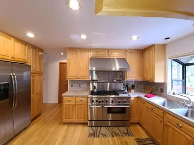 a kitchen with wooden cabinets and stainless steel appliances at IVH0869 - Cinnabar Creek home in Incline Village