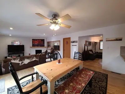 a living room with a table and a ceiling fan at IVH0869 - Cinnabar Creek home in Incline Village