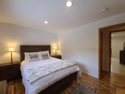 a bedroom with a bed with two night stands and a mirror at IVH0869 - Cinnabar Creek home in Incline Village