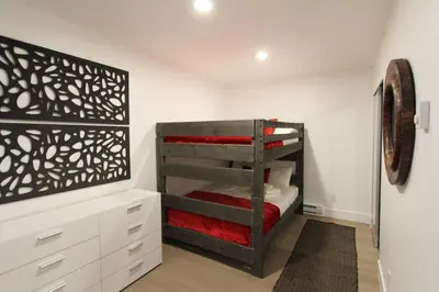 a bedroom with a bunk bed with red sheets at LVC0615 - Lake Therapy condo in Zephyr Cove