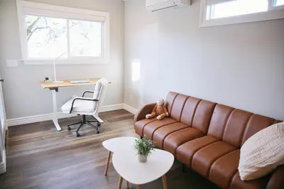 a living room with a brown couch and a table at A Luxury Yosemite Retreat in Mariposa