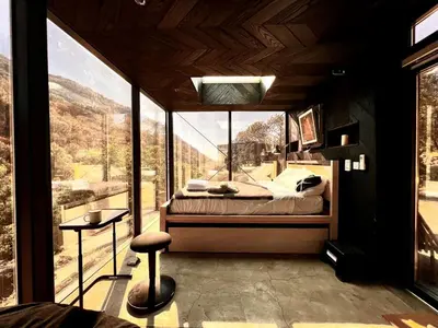 a bedroom with a bed and a large window at Spacious and Luxurious Barn in Three Rivers, California in Three Rivers