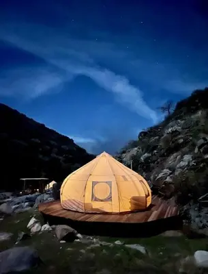 a yellow tent sitting on a wooden platform at Spacious and Luxurious Barn in Three Rivers, California in Three Rivers