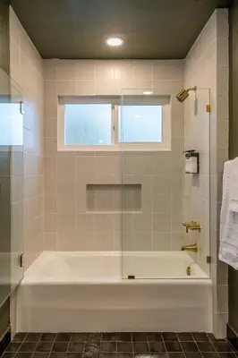 a bathroom with a tub and a window at Sequoia Retreat - Scenic Pool, Hot Tub, & Trails in Three Rivers
