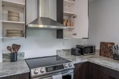 a kitchen with a stove and a microwave at Sequoia Retreat - Scenic Pool, Hot Tub, & Trails in Three Rivers