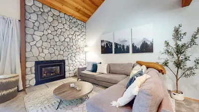 a living room with a couch and a fireplace at Snowcreek IV #594 condo in Mammoth Lakes