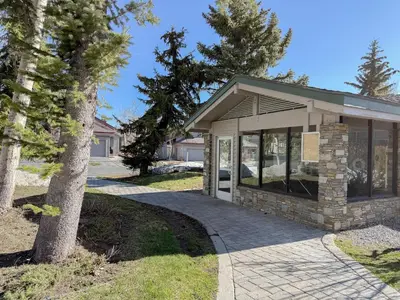 a home with a walkway in front of a building at Snowcreek IV #594 condo in Mammoth Lakes