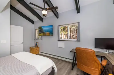 a bedroom with a bed and a desk and a tv at Mountain Retreat - Lake Tahoe - Incline Village - Private Garage in Incline Village