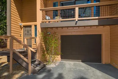 a house with a garage door and a balcony at Mountain Retreat - Lake Tahoe - Incline Village - Private Garage in Incline Village