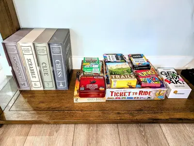 a pile of books sitting on a wooden shelf at Mountain Retreat - Lake Tahoe - Incline Village - Private Garage in Incline Village