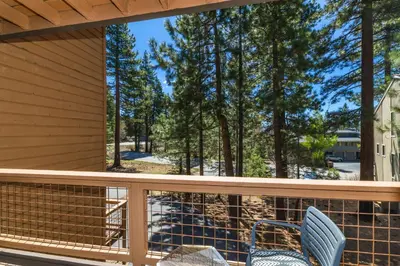 a balcony with two chairs and a view of trees at Mountain Retreat - Lake Tahoe - Incline Village - Private Garage in Incline Village