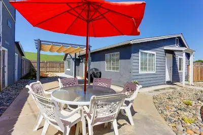 a table with a red umbrella on a patio at Mtn-View Home with Patio and Grill in Woodlake in Woodlake
