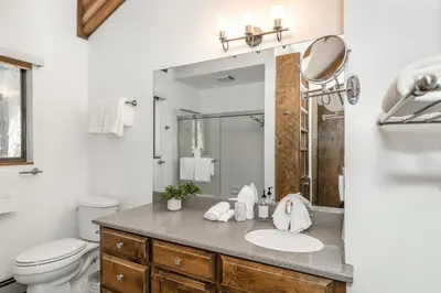 a bathroom with a sink and a toilet and a mirror at Mountain Getaway - Lake Tahoe - Incline Village - Private Garage in Incline Village
