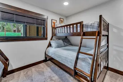 a bunk room with two bunk beds and a ladder at Fire & Ice Spacious Retreat with Hot tub and Fireplace in Truckee