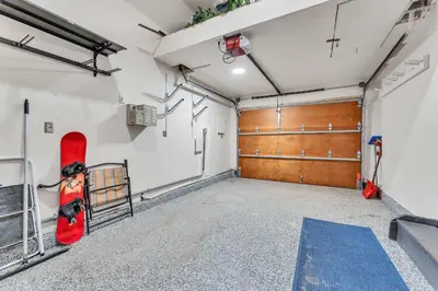 a garage with a snowboard hanging on the wall at Fire & Ice Spacious Retreat with Hot tub and Fireplace in Truckee