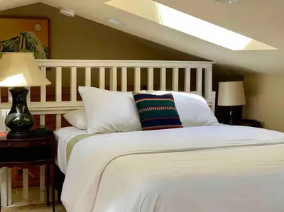 a bedroom with a white bed with a pillows at Lake Front-Near Yosemite-Pool Table-Private Dock -PML in Groveland