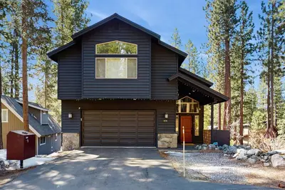 a black house with a garage at The Tahoe Timber House in South Lake Tahoe