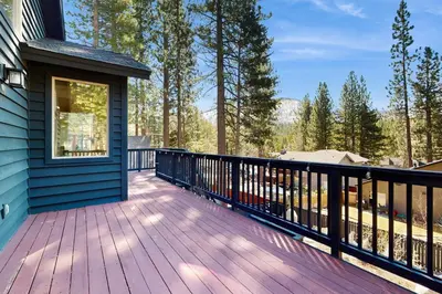 a deck on a house with a blue house at The Tahoe Timber House in South Lake Tahoe