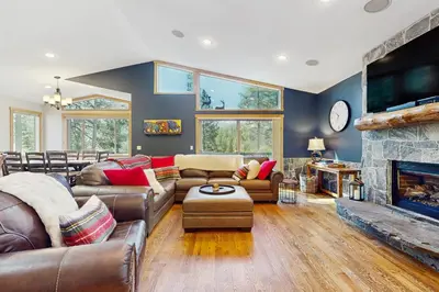 a living room with leather furniture and a fireplace at The Tahoe Timber House in South Lake Tahoe