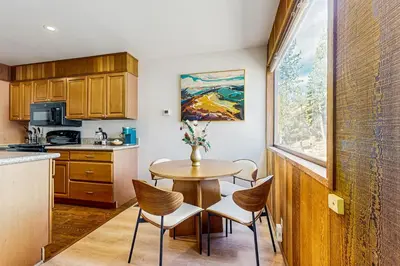 a kitchen with a table and chairs and a window at Lake Tahoe Adventure Base! Townhome with Pool Access in Wood Vista