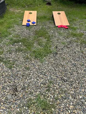 two wooden ping pong tables sitting on the grass at Modern 2 Bedrm Kids, Dog, Hot Tb, Game Room, 9 min Bass Lake in Oakhurst