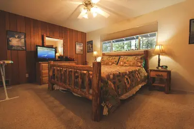 a bedroom with a large bed and a television at HCC0612 - Sitzmark Ski Condo townhouse in South Lake Tahoe
