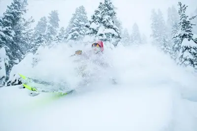 a person is skiing down a snow covered slope at Spacious 5BDR Lake View Home w Hot Tub Close to Slopes Town Beach in Tahoe City